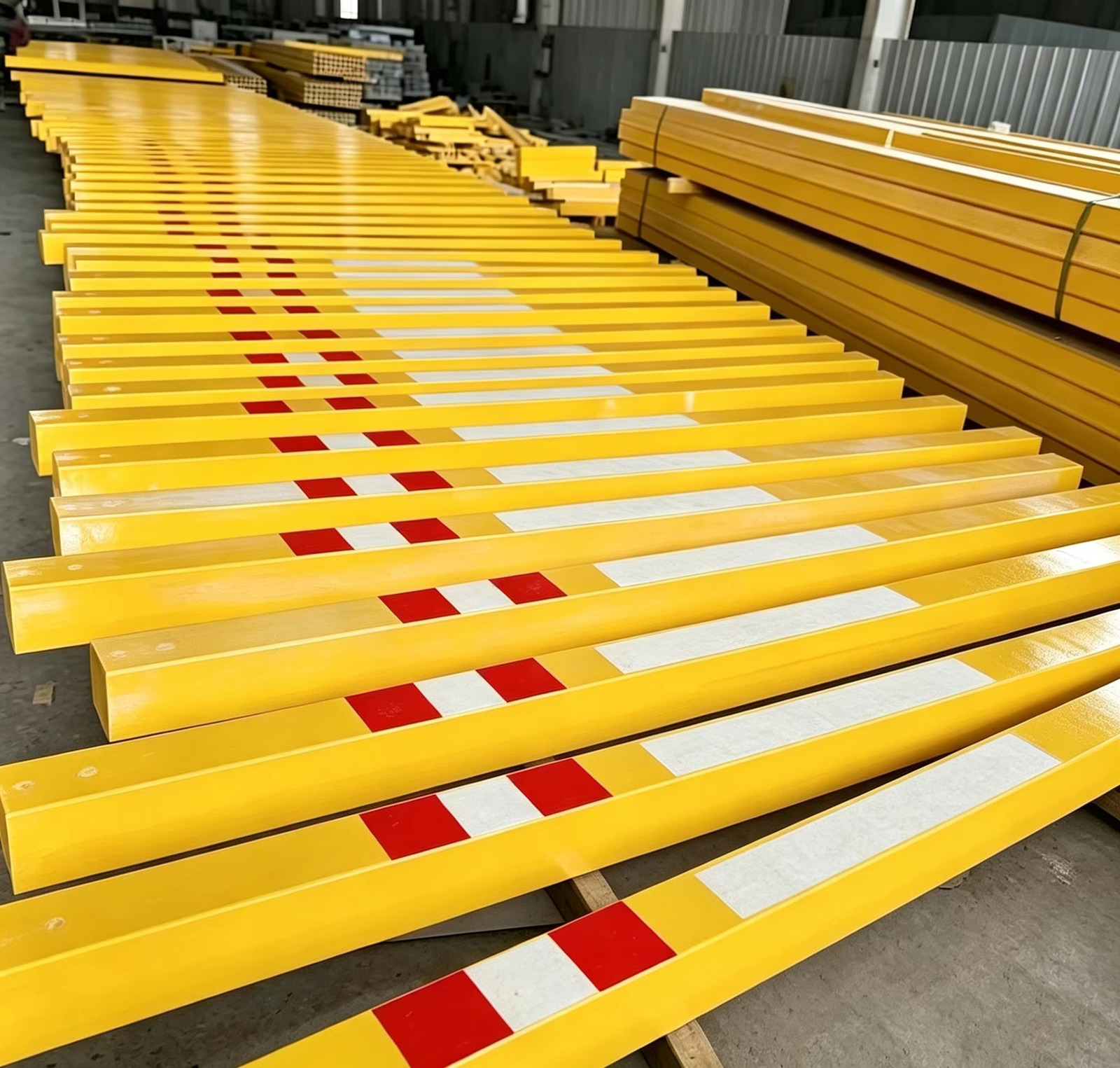 Hollow profiles strapped in bundles and staged at the production line, with reflective end marking on every bundle